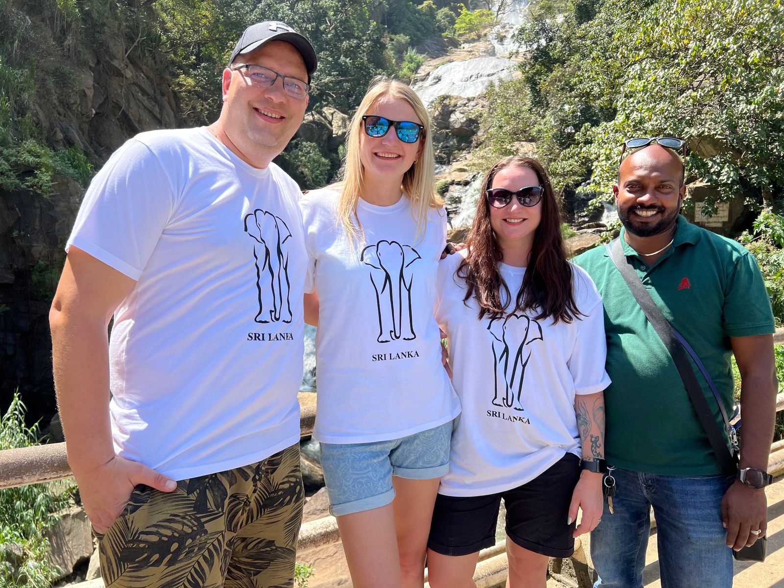 A group enjoying a visit to a waterfall