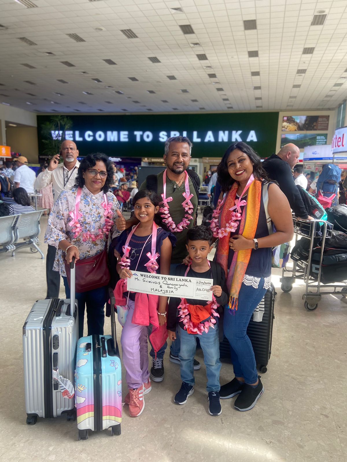 Travellers with luggage at an airport arrival area