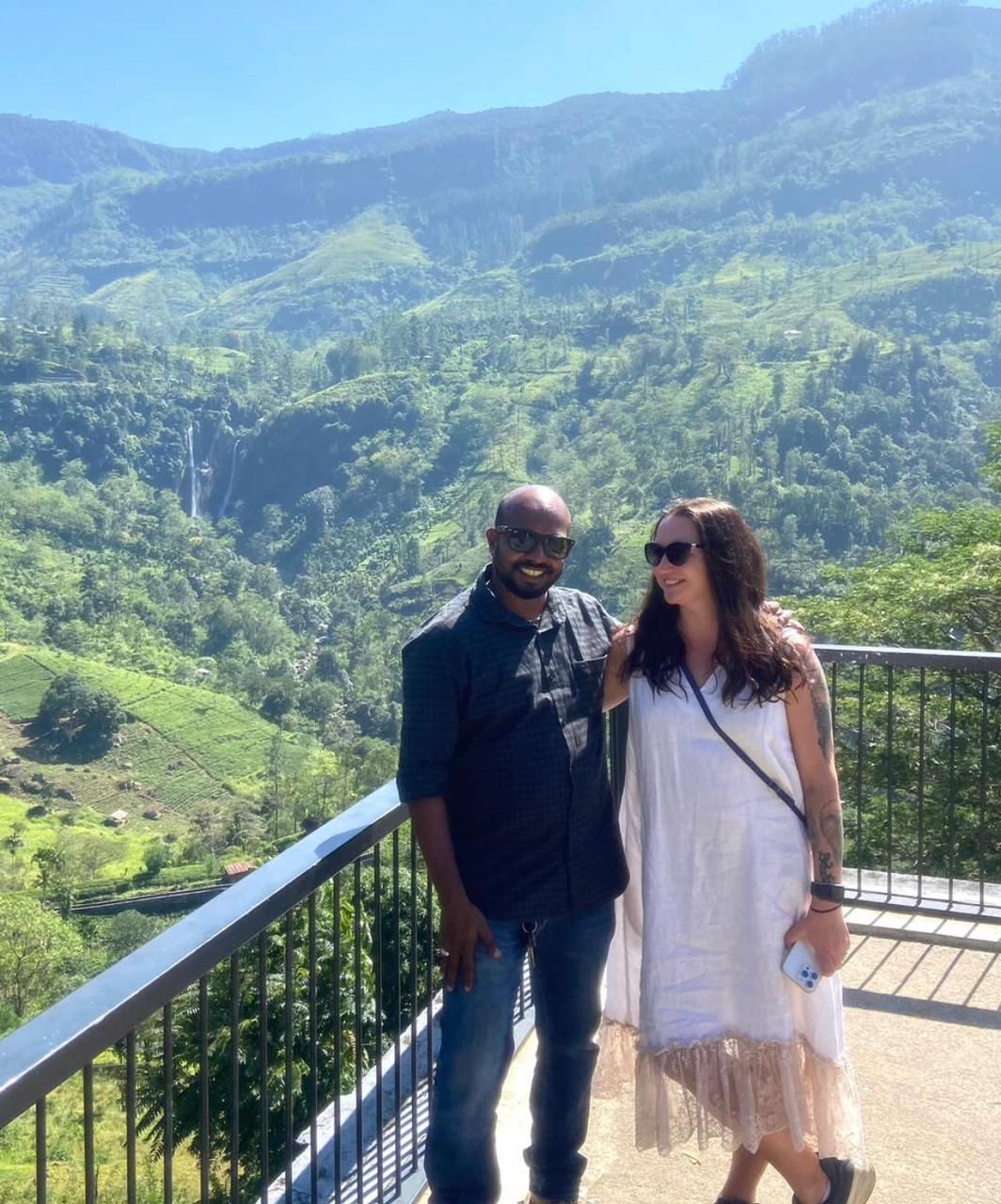 Two travellers overlooking a green valley