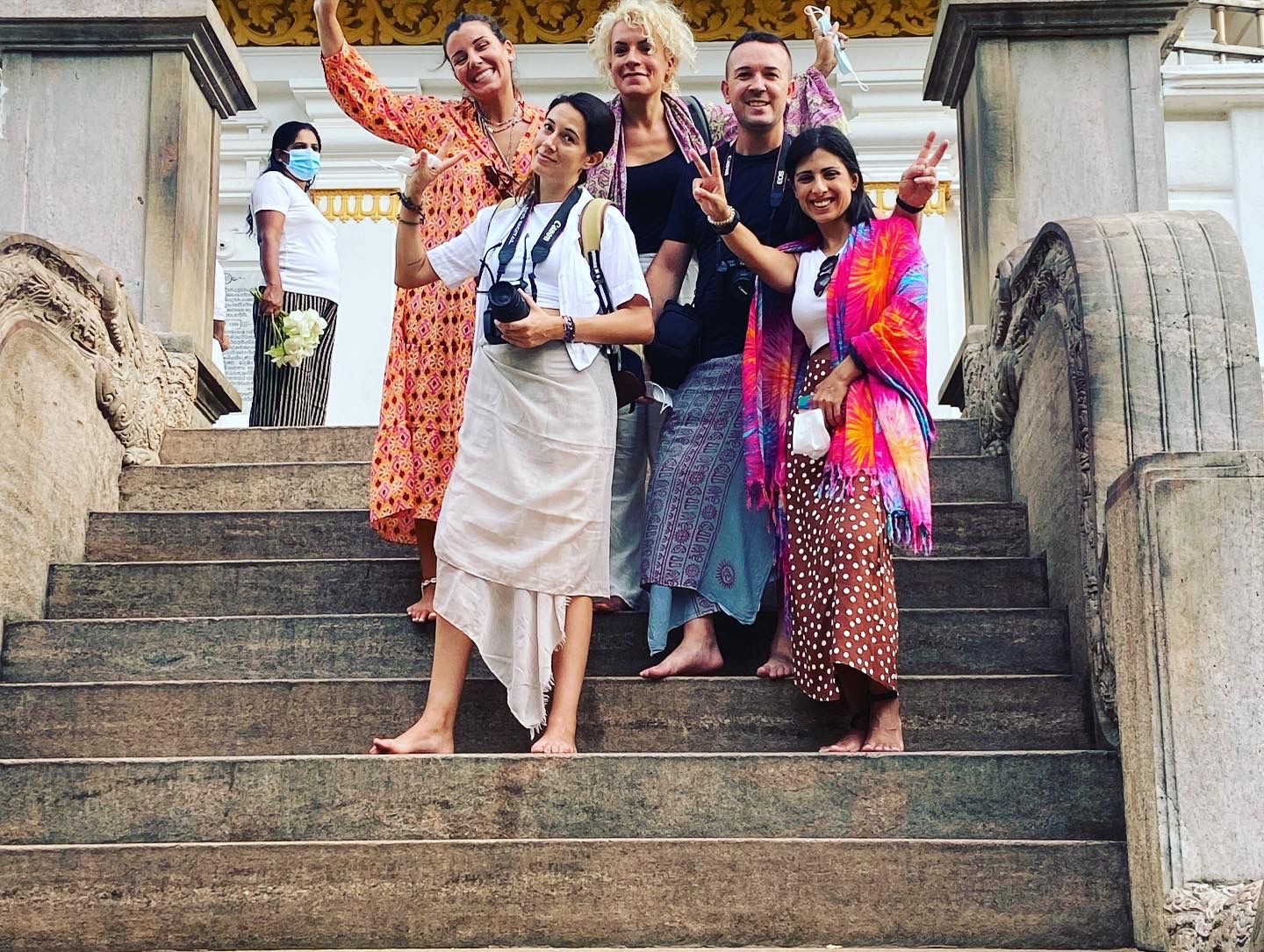 Travellers posing together on stone steps